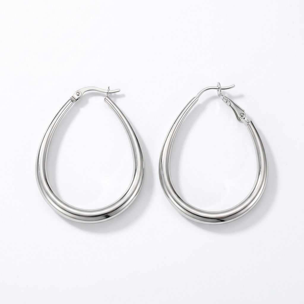 Silver-tone polished teardrop hoop earrings on white